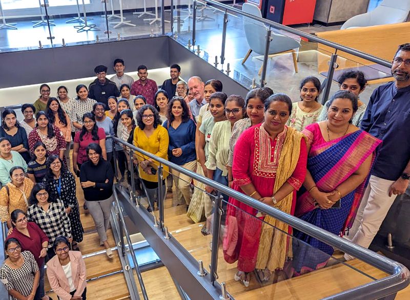 More than three dozen MathWorks India employees standing on a set of stairs and smiling at the camera.