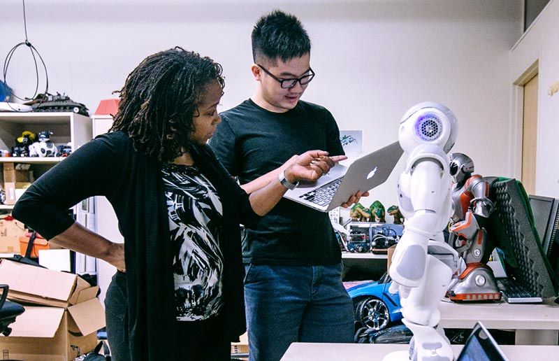 Dr. Ayanna Howard and graduate student, Jin Xu, setting up the NAO robot.