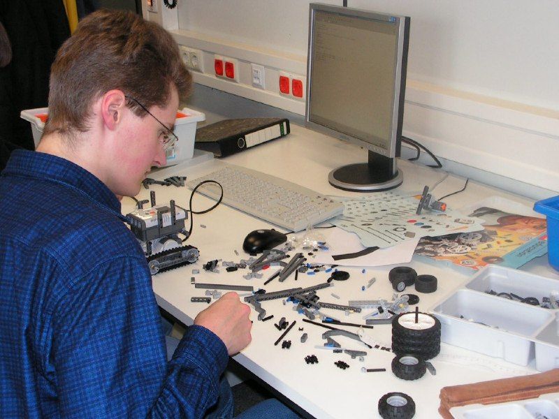 A freshman engineer selects components from a LEGO MINDSTORMS NXT kit