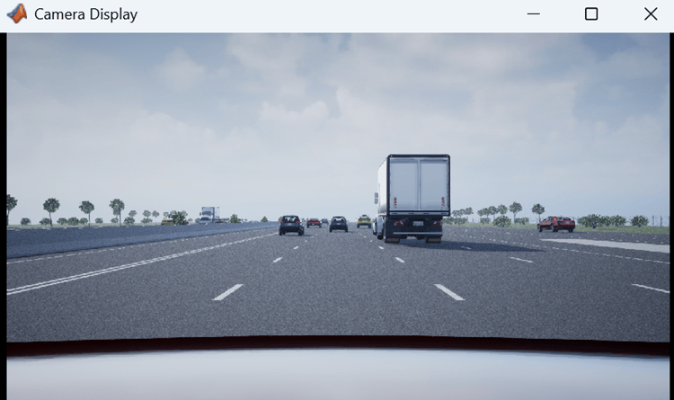 Front-facing camera view from the ego vehicle showing the highway and traffic.