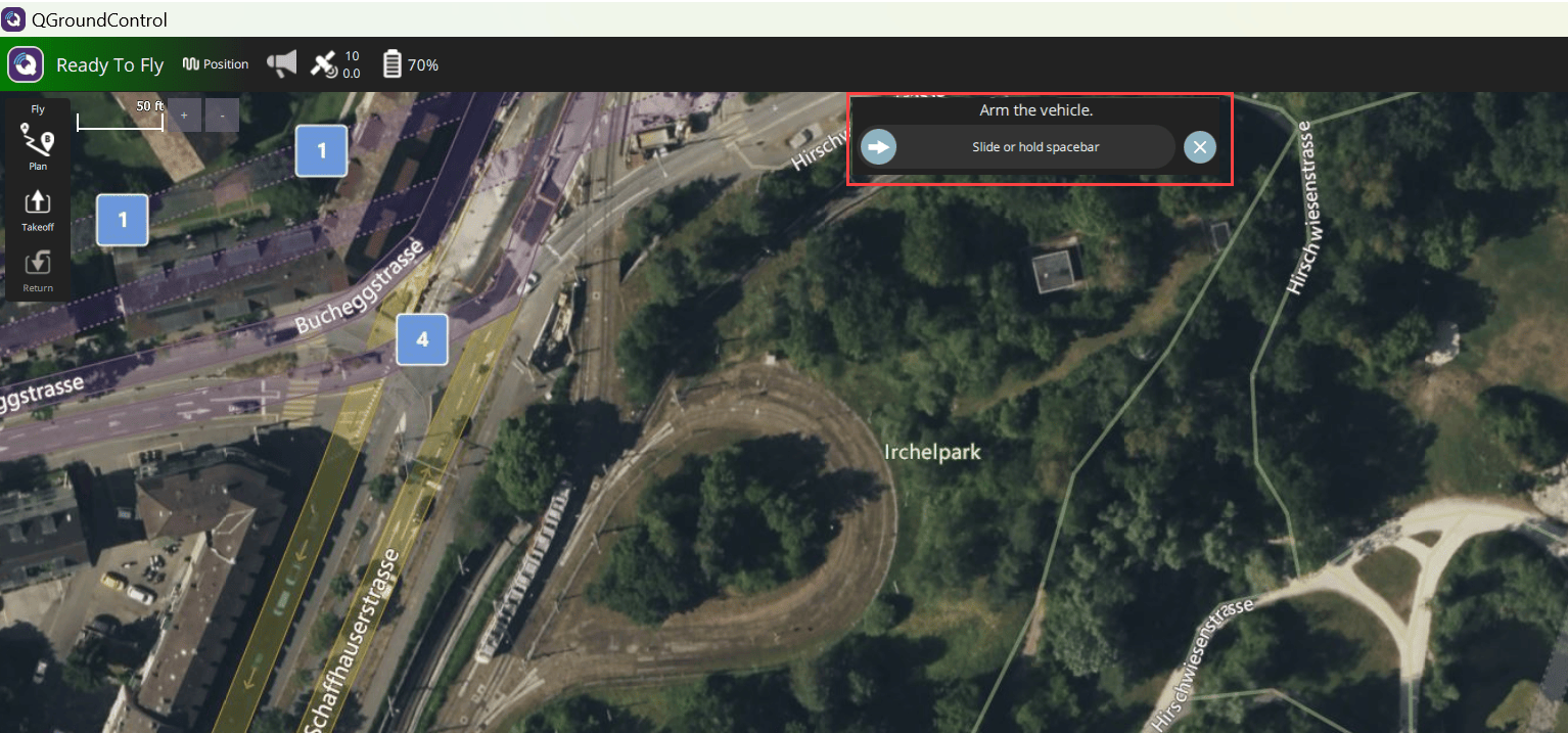 QGroundControl Fly View with Arm the vehicle dialog prompt displayed over satellite map