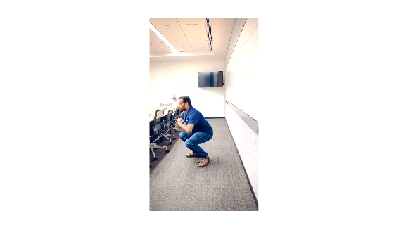 Person performing a squat in an office